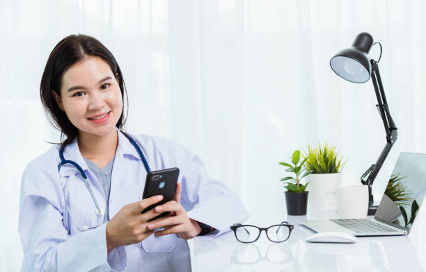 istock Doctor woman smiling using working with smart mobile phone 1275752980