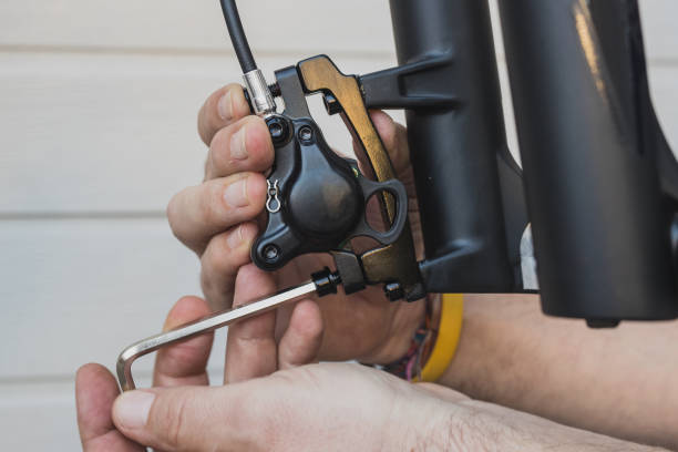 tightening or removing disc brake caliper on a mountain bike. - fork wrench imagens e fotografias de stock