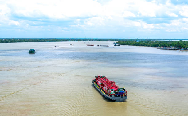 Tien Giang, Vietnam - September 2nd, 2020: Ships transporting gas on the Lower Mekong River are rich in alluvium in the mornings of summer, helping economic development in Tien Giang, Vietnam