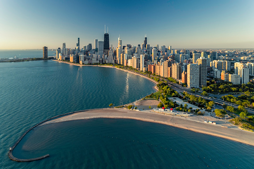 View of the Chicago, Illinois waterfront and skyline with concrete path next to Lake Michigan at dawn