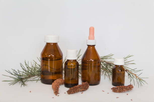 istock Bottles with cedar oil. Aromatherapy and natural cosmetics concept 1275756410