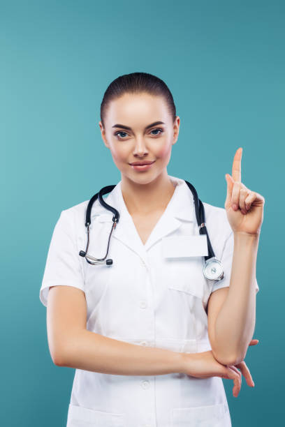 istock Beautiful doctor pointing up 1275760790