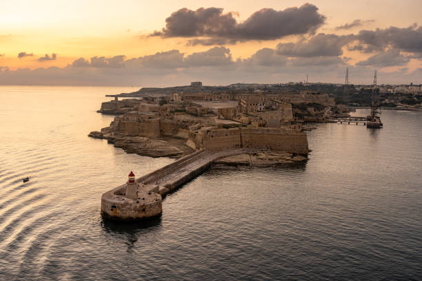istock view on lighthouse of valetta at sunset, malta 1275760879