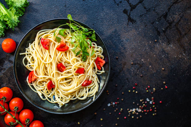 istock pasta spaghetti tomato salad noodles vegetable macaroni semola durum wheat serving size top view copy space for text food background rustic 1275761601