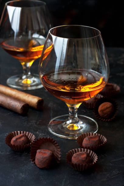 istock Whiskey or cognac  in  glass with  truffles candy on  dark background 1275763708