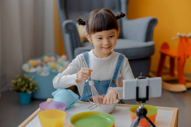 istock Cute Little Asian Kid doing online broadcasting 1275766461