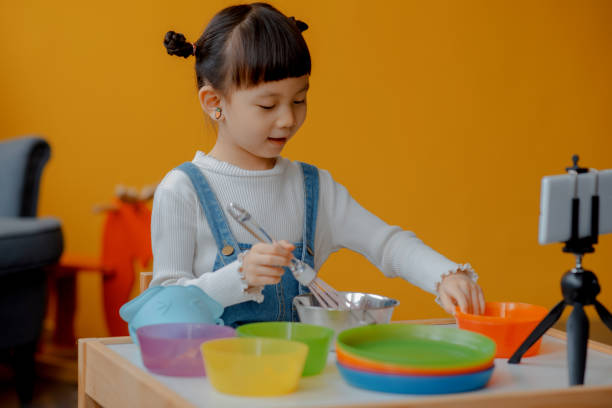 istock Cute Little Asian Kid doing online broadcasting 1275766472