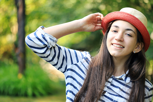 Portrait of a beautiful girl wearing hat in the nature