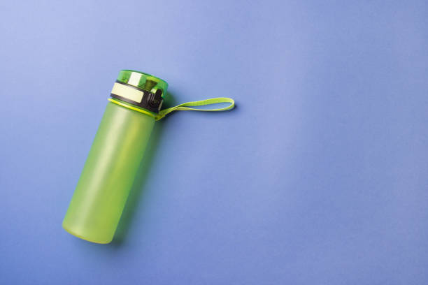 istock green plastic sport bottle lying on left side of blue background with copy space 1275771376