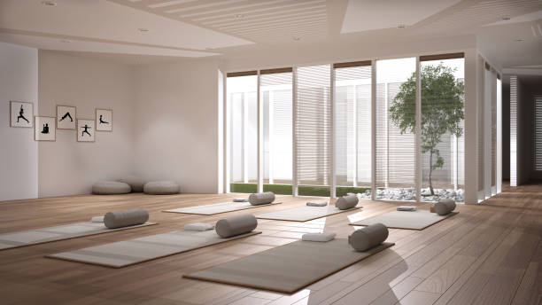 istock Empty yoga studio interior design, open space with mats, pillows and accessories, parquet, patio house, inner garden with tree and pebbles, ready for yoga practice, meditation room 1275773038