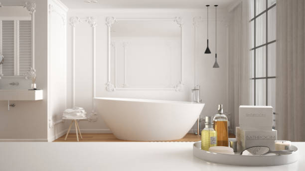 istock Spa, hotel bathroom concept. White table top or shelf with bathing accessories, toiletries, over blurred luxury minimalist bathroom, modern architecture interior design 1275773054