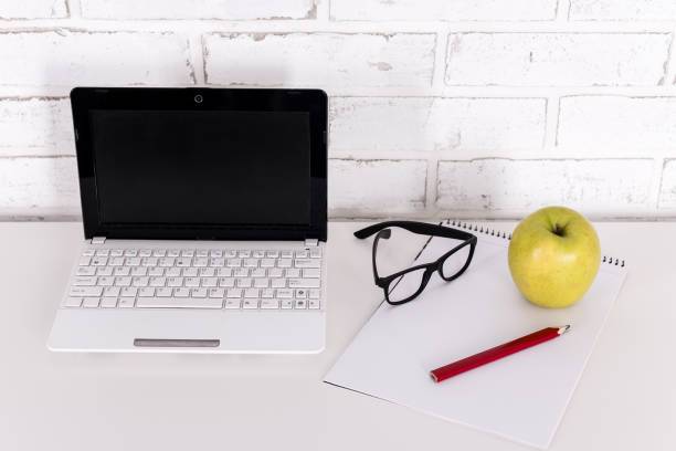 istock workplace at home or in office - modern laptop, glasses and notebook on the table 1275774170