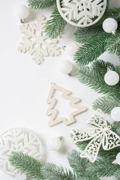 istock Christmas background. White decorations on spruce branches on a white background. Christmas Flatly. Top view from copyspace 1275775373