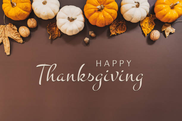 istock Happy Thanksgiving Day with pumpkin and nut on the table 1275776749