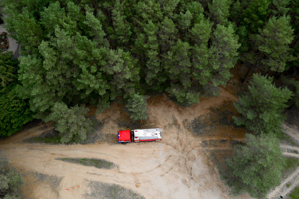 istock fire truck in the forest top view from a drone. 1275777733