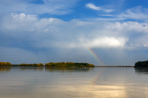istock Landscape on the river with a rainbow in the sky 1275777808
