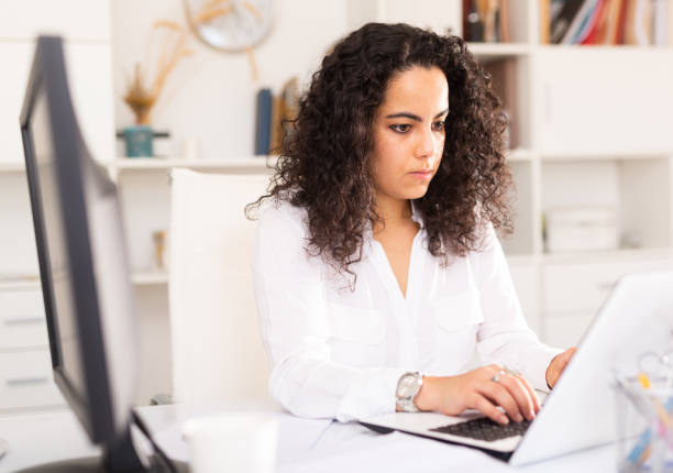 istock Young positive woman working at office 1275779090