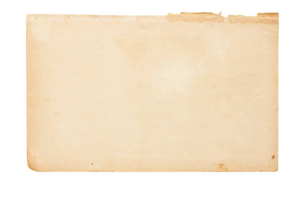 istock Sheet of old yellowed paper with uneven torn edges 1275781157