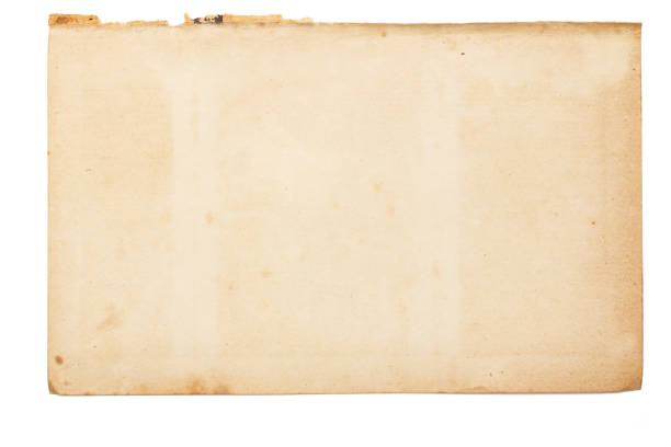 istock Sheet of old yellowed paper with uneven torn edges 1275781184