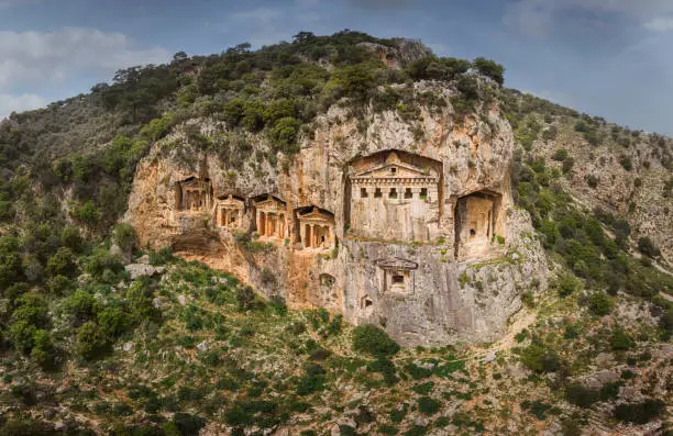 Above the river's sheer cliffs are the weathered façades of Lycian tombs cut from rock, circa 400 BC.