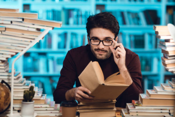 istock A man sits at a table lowered his glasses. 1275787194