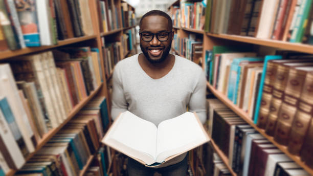 istock Ethnic African American guy reading book. 1275788462