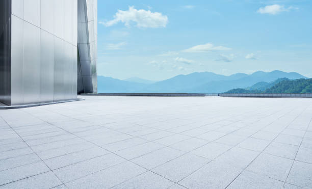 istock Empty concrete tiles floor with modern architecture and beautiful landscape 1275788647