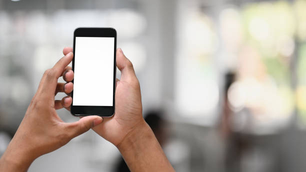 istock Closeup hands holding empty screen of smartphone with blur background. 1275790901