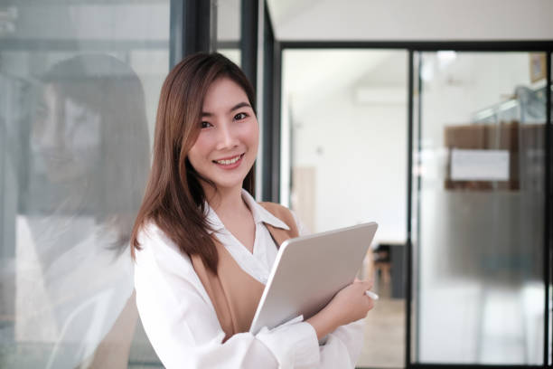 istock Secretary woman holding a tablet computer and smile on face. 1275790974