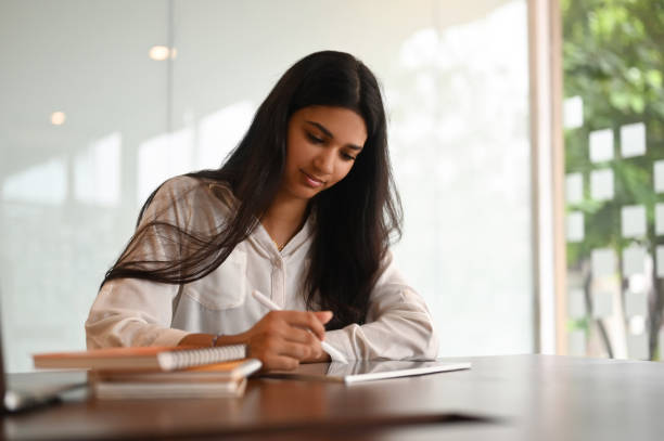 istock Portrait of bussiness woman planning work schedule writing in notebook while sitting at office. 1275791057