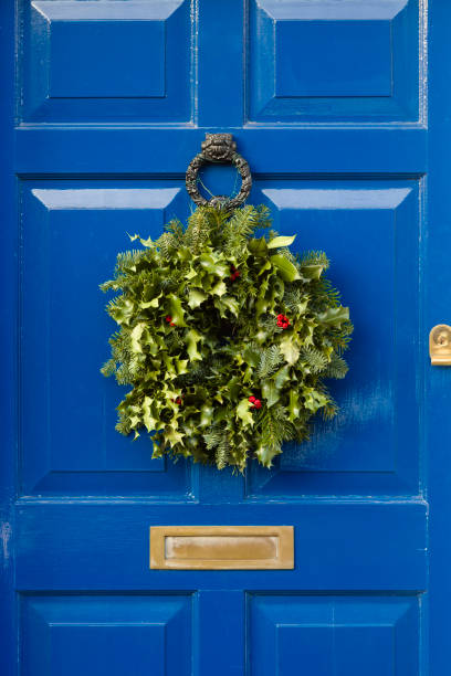 istock Blue front door with Christmas garland wreath 1275791473