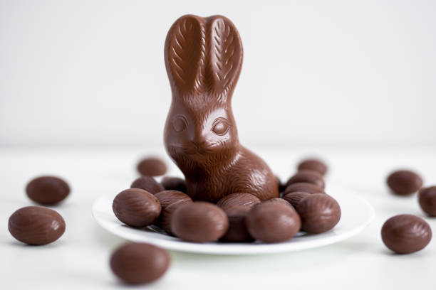 istock Easter concept - close up of chocolate bunny and eggs over white 1275792548