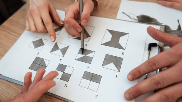 Man hand holds pencil to make a mark on test.