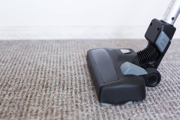 istock housekeeping concept - modern vacuum cleaner over carpet 1275792767