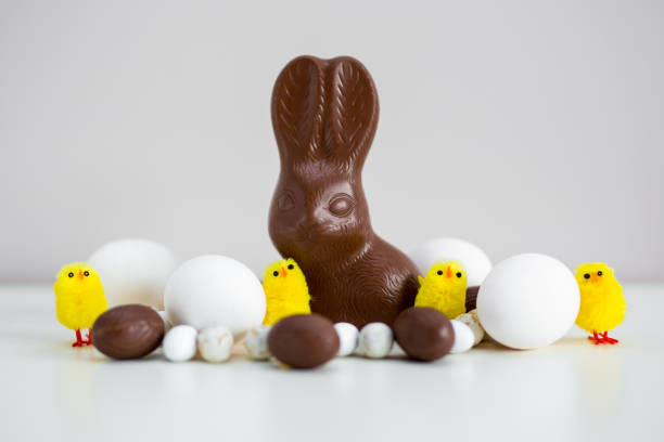 Easter background  - close up of Easter eggs, chocolate bunny and sweets over grey background