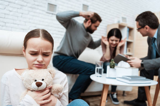 istock Girl hugs a bear while dad swung at mom. 1275794221