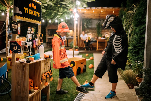 istock Two kids at Halloween party practicing social distancing and foot tapping as an new handshake alternative 1275794330