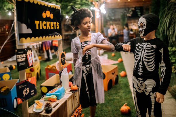 istock COVID-19 alternative handshakes on Halloween party 1275794338