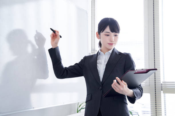istock Japanese woman writing on a whiteboard 1275794579