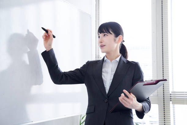 istock Japanese woman writing on a whiteboard 1275794621