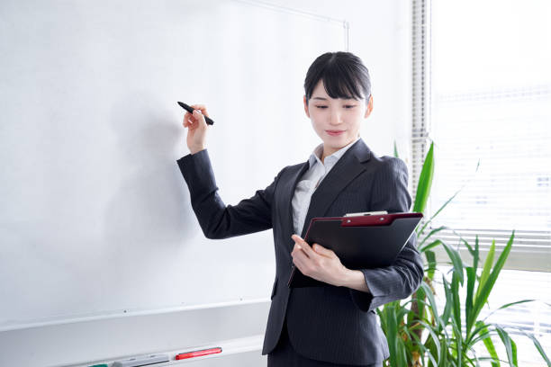 istock Japanese woman writing on a whiteboard 1275794676
