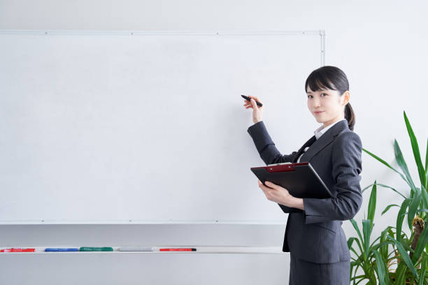 Japanese woman writing on a whiteboard