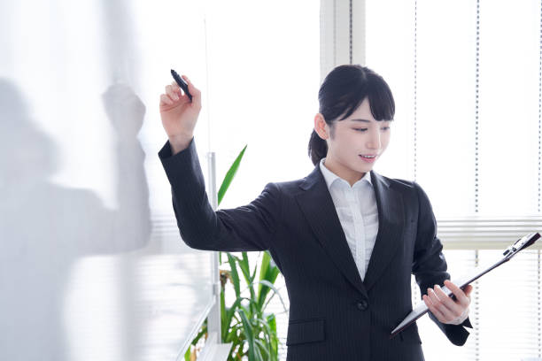 istock Japanese woman writing on a whiteboard 1275794832