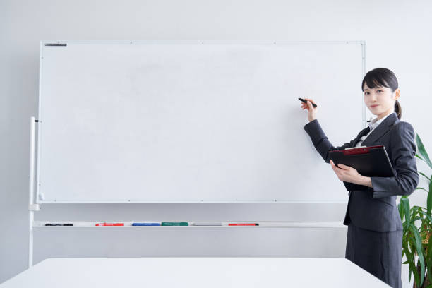 istock Japanese woman writing on a whiteboard 1275794964