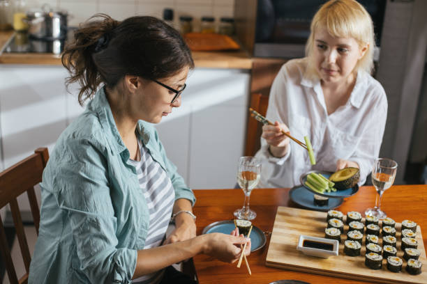 istock Two friends eating sushi 1275796135