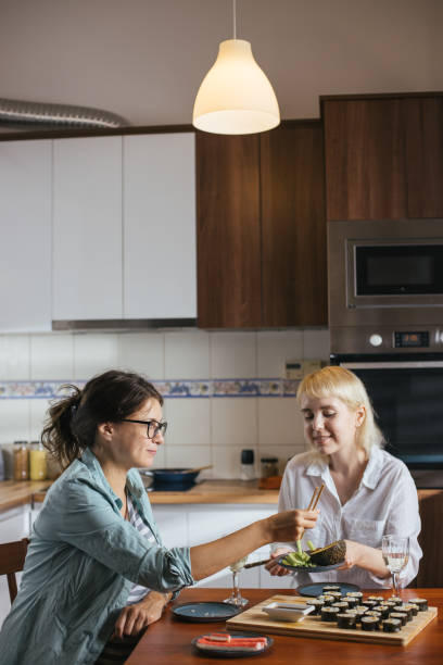istock Two friends eating sushi 1275796136
