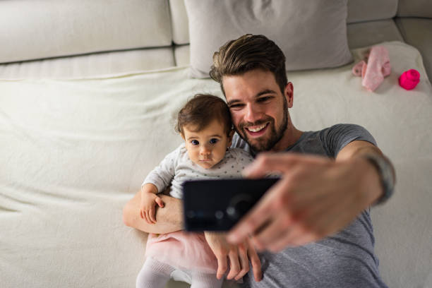 istock Beautiful father and daughter taking selfie 1275796478
