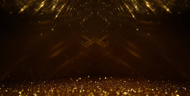 istock background of abstract gold and black glitter lights. defocused 1275797210
