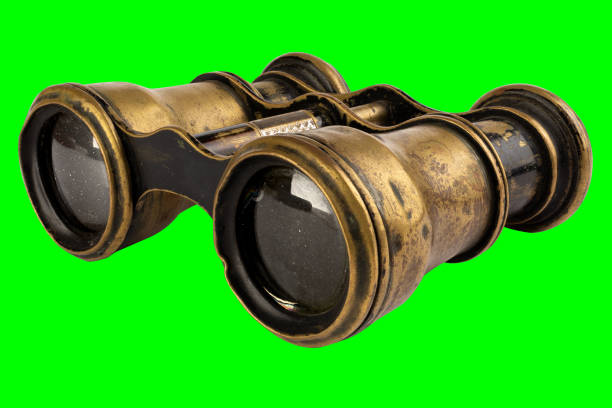 Old and used brass binoculars with dust and scratches