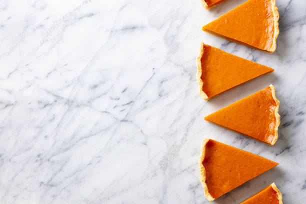 istock Pumpkin pie, tart pieces for Thanksgiving day. Marble background. Copy space. Top view. 1275798720